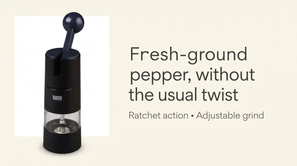 Black Kuhn Rikon ratchet pepper grinder with a dark handle and a clear chamber at the base.
